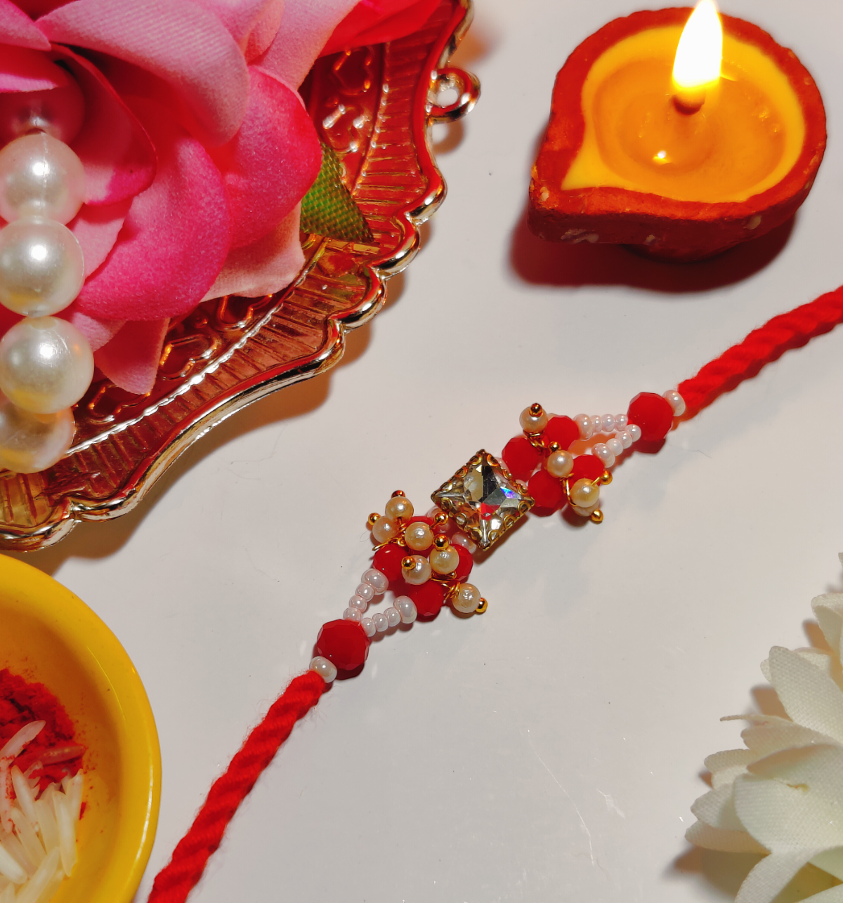 House Of Festivals Premium Sparkling Stone Rakhi with Intricate Moti Design - Elegant Craft