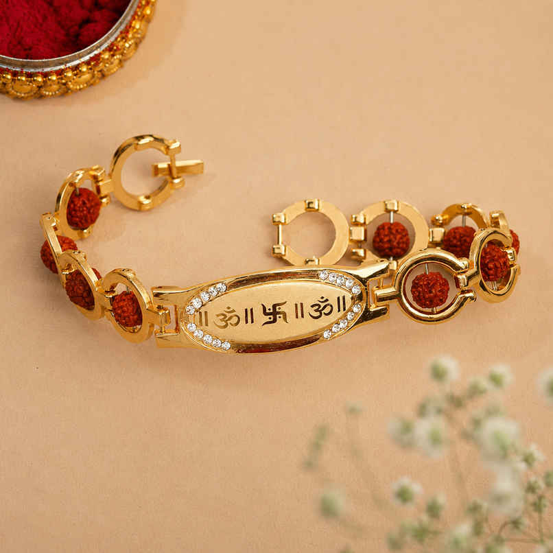 Religious Brown & Golden Om, Swastik Symbol, Rudraksha Designer Bracelet Rakhi for Brother & Roli Chawal Pack (eCraftIndia) Religious Brown & Golden Om, Swastik Symbol, Rudraksha Designer Bracelet Rakhi for Brother & Roli Chawal Pack (eCraftIndia)