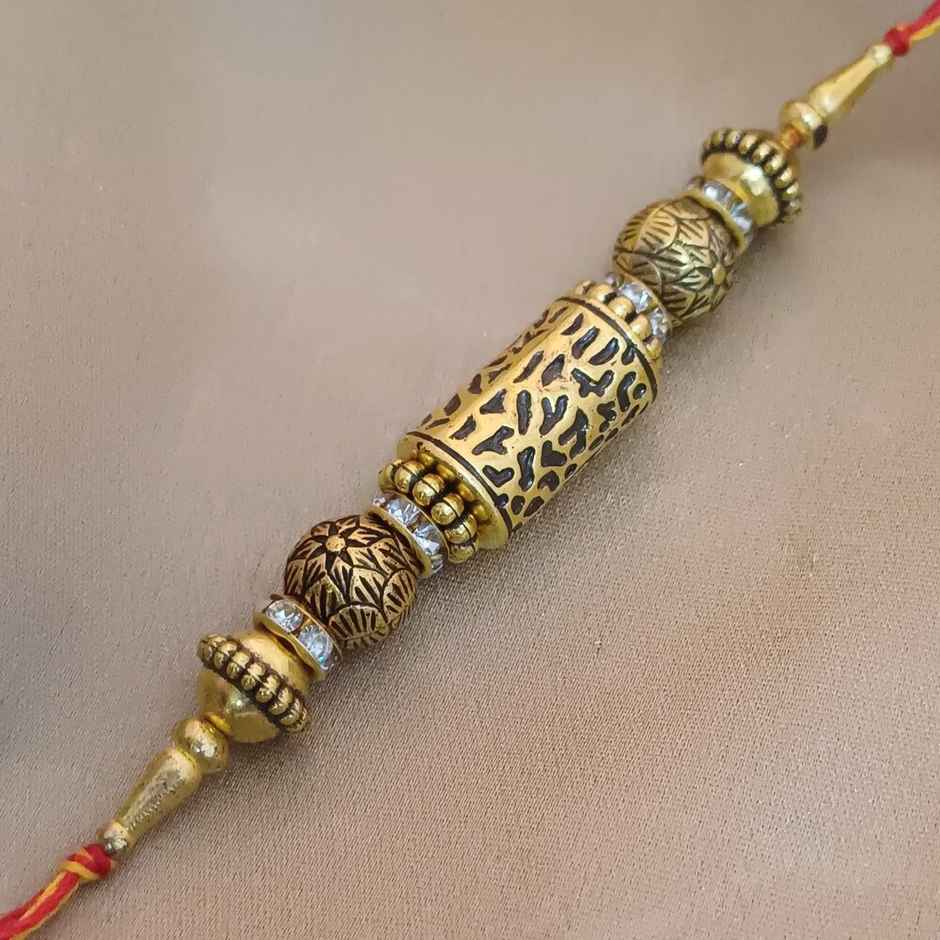 Antique Gold Taveej Rakhi | Traditional Design | Gullak