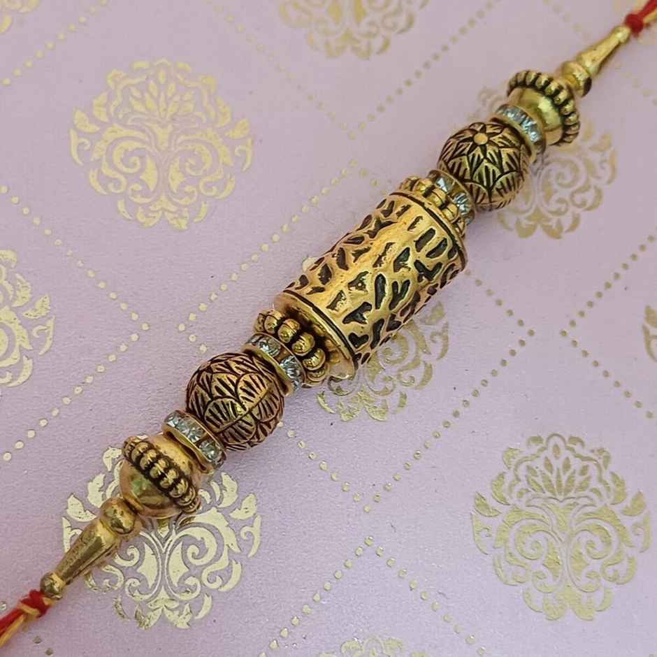 Antique Gold Taveej Rakhi | Traditional Design | Gullak