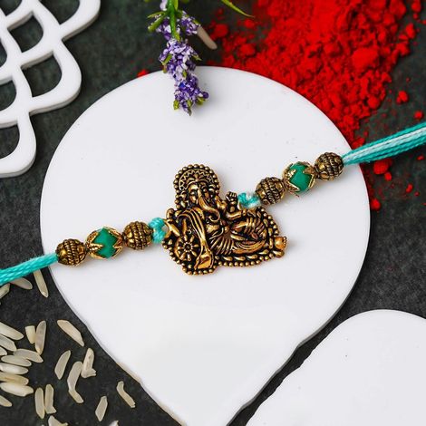 Religious Golden Lord Ganesha Designer Raksha Bandhan Rakhi for Bhai Bhaiya with Roli Chawal Pack (eCraftIndia)