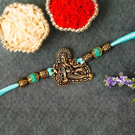 Religious Golden Lord Ganesha Designer Raksha Bandhan Rakhi for Bhai Bhaiya with Roli Chawal Pack (eCraftIndia)