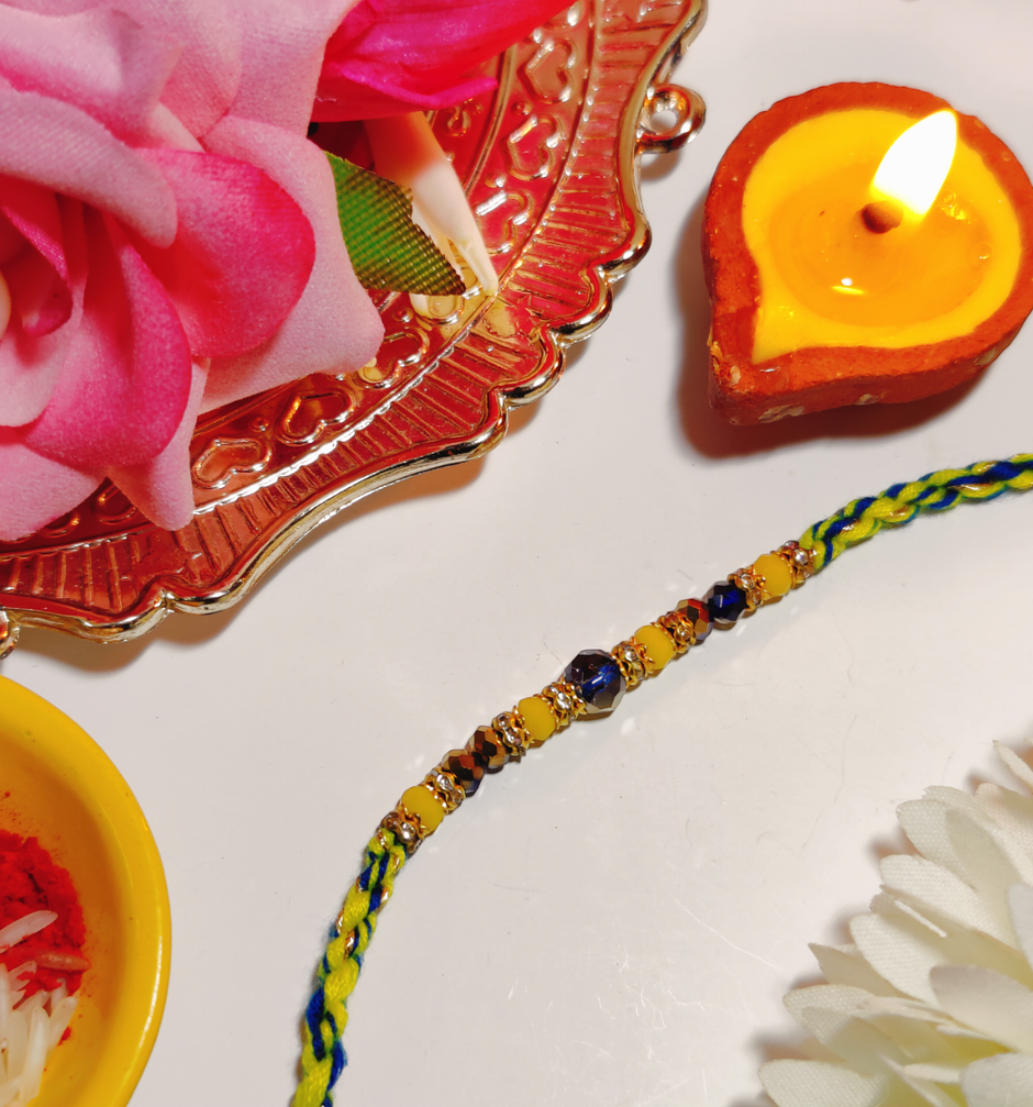 House Of Festivals Beautifully Weaved Dori Rakhi With Yellow & Blue Moti - Traditional Rakhi