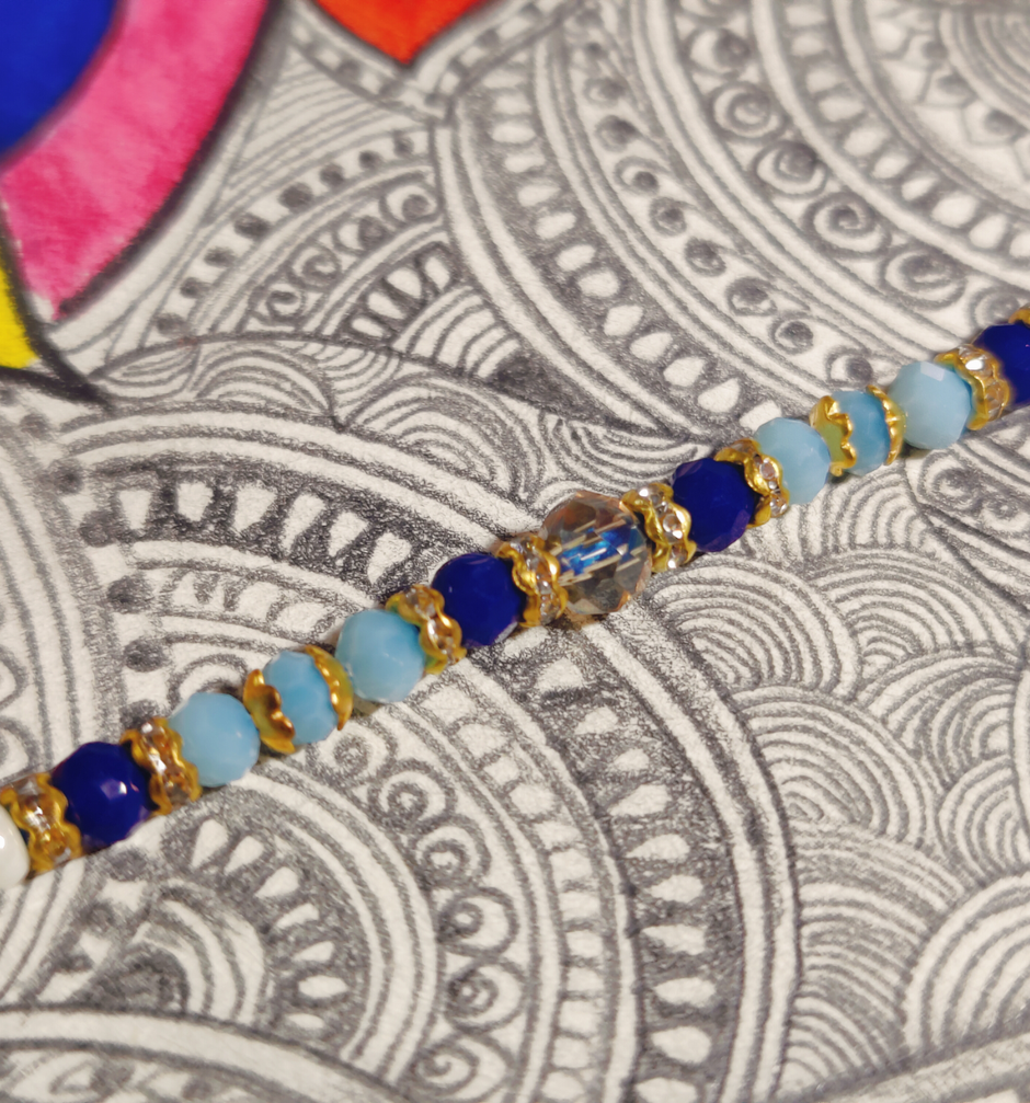 Amul Fruit 'N' Nut Chocolate(150gms) & Beautifully Weaved Dori Rakhi With Blue & White Shade Moti(1pc) Combo