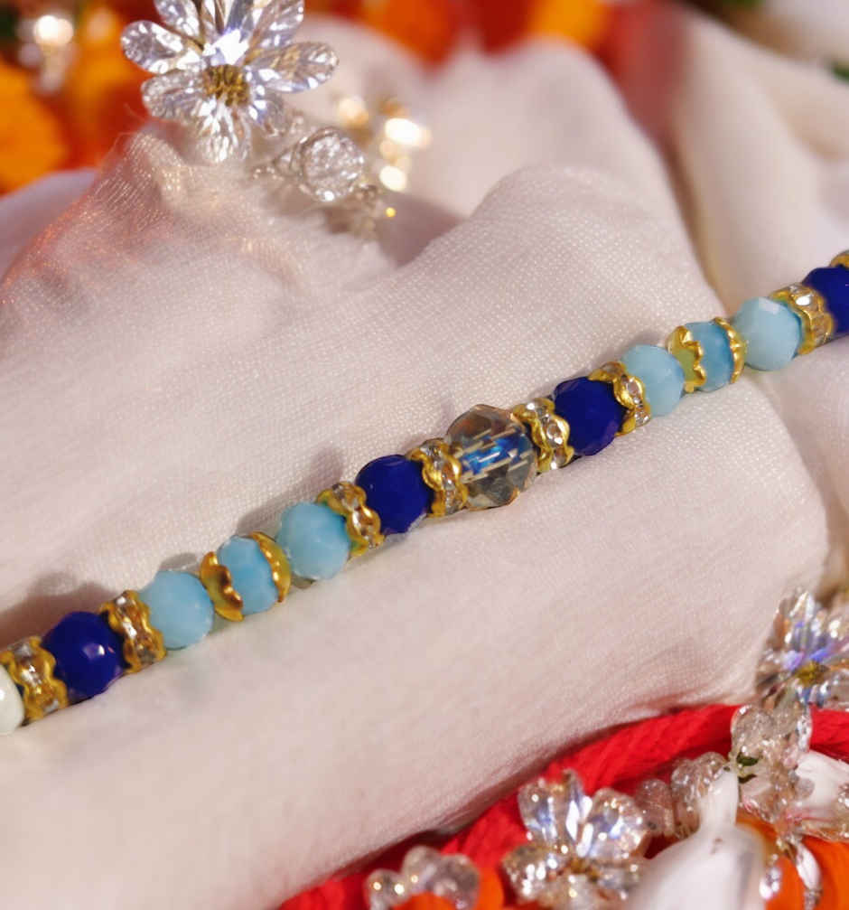 Amul Fruit 'N' Nut Chocolate(150gms) & Beautifully Weaved Dori Rakhi With Blue & White Shade Moti(1pc) Combo