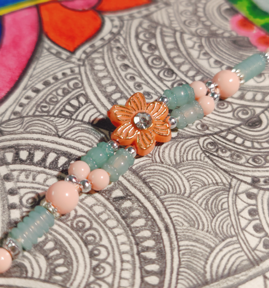 Daadi'S Besan Laddoo Pure Ghee(200gms) & Pastle Green & Pink Flower Design Rakhi(1pc) Combo