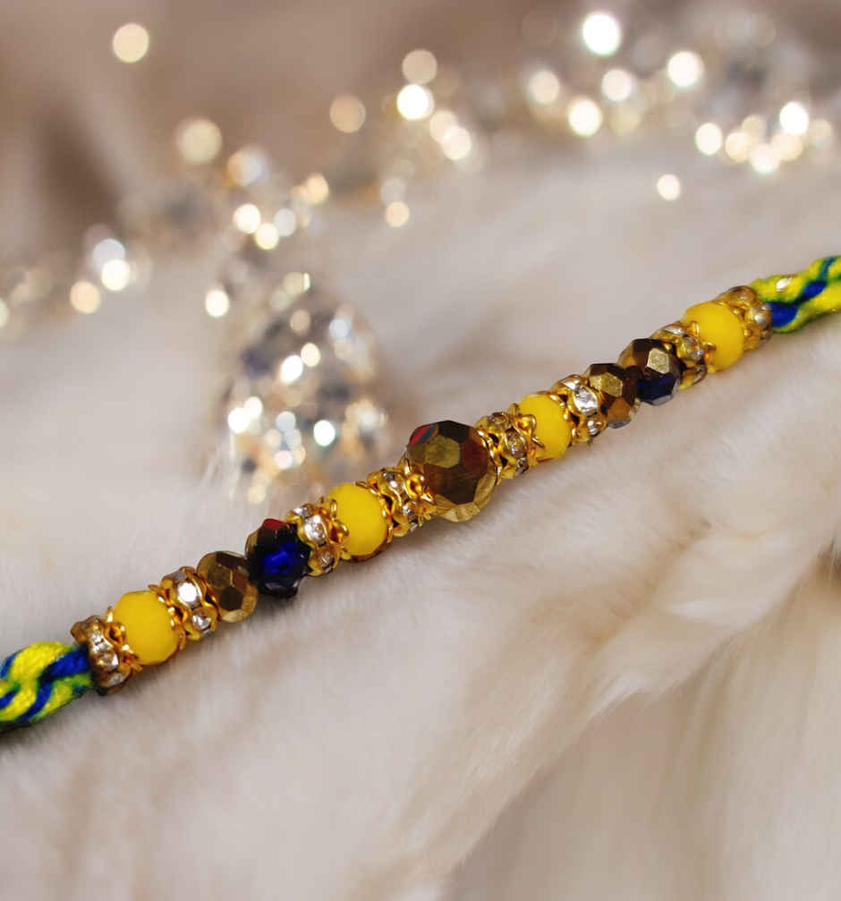 House Of Festivals Beautifully Weaved Dori Rakhi With Yellow & Blue Moti - Traditional Rakhi