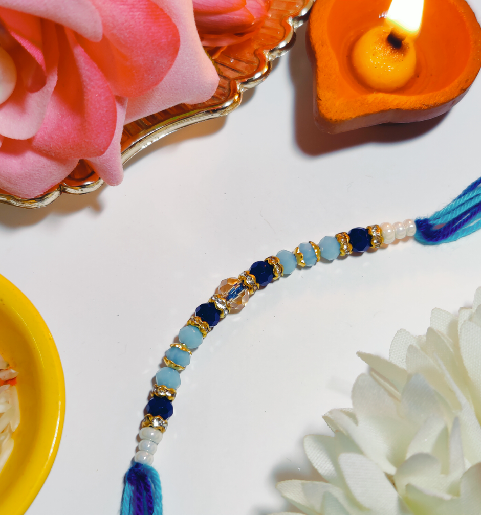 Amul Fruit 'N' Nut Chocolate(150gms) & Beautifully Weaved Dori Rakhi With Blue & White Shade Moti(1pc) Combo