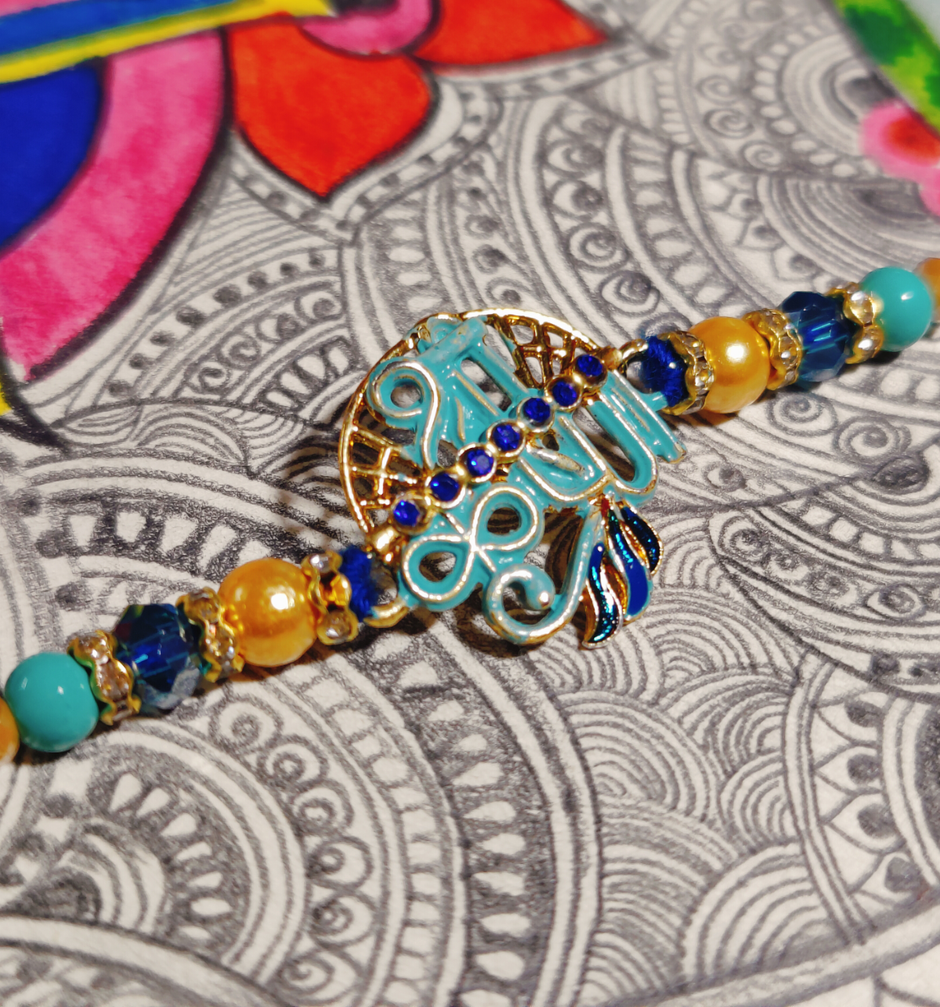UNIBIC Swaadesi Shahi Kaju Katli Box(240Gms) & Blue Shade Shree Krishna Metal Pendant Rakhi With Moti(1Pc) Combo