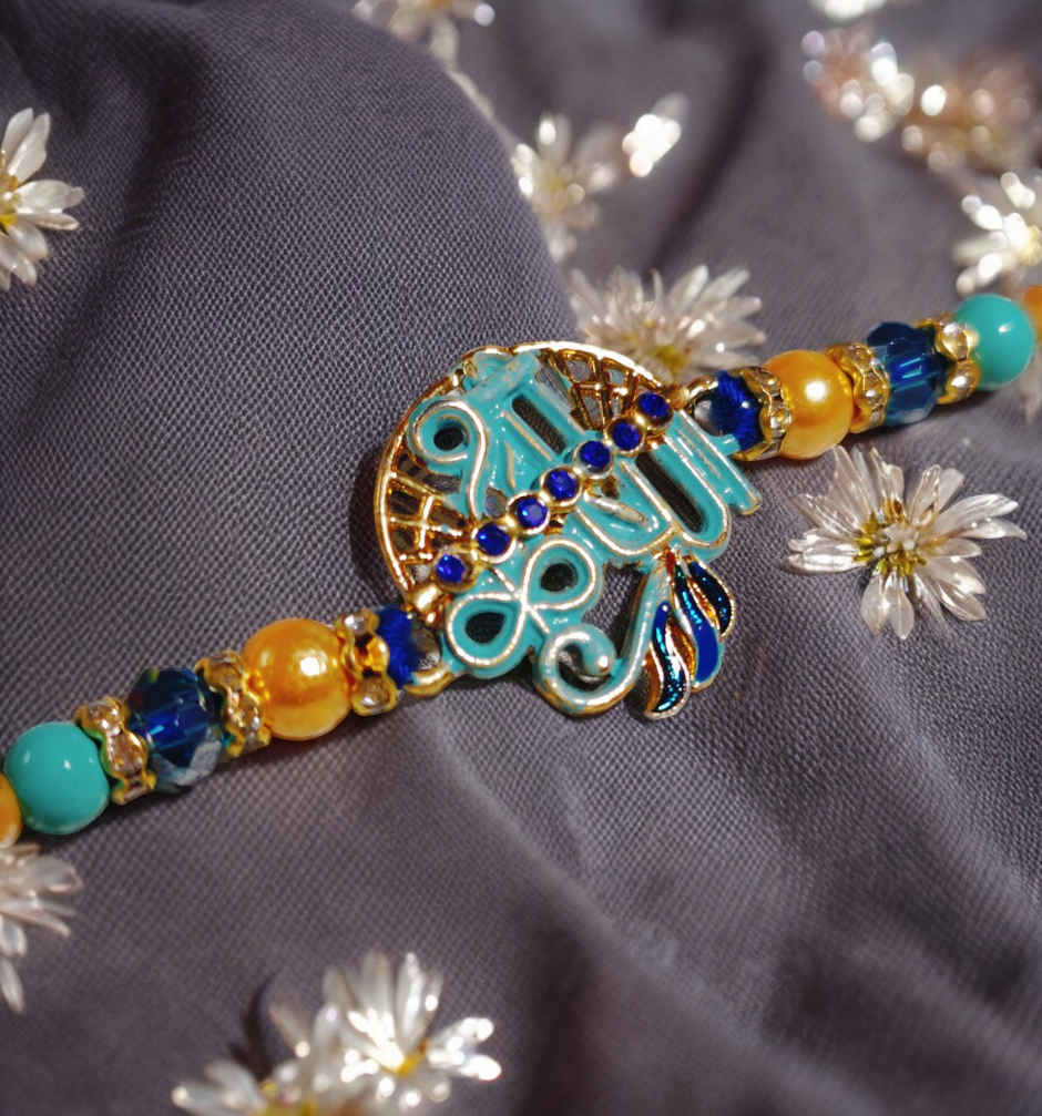 UNIBIC Swaadesi Shahi Kaju Katli Box(240Gms) & Blue Shade Shree Krishna Metal Pendant Rakhi With Moti(1Pc) Combo
