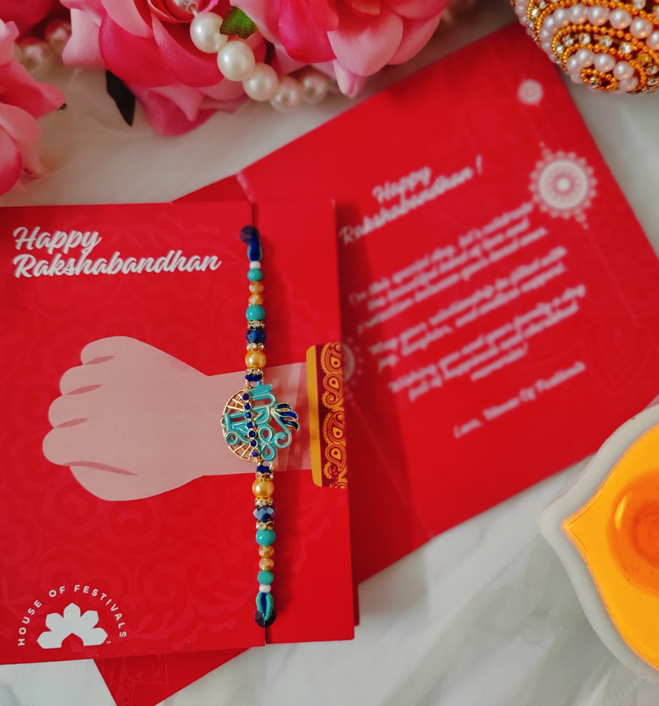 UNIBIC Swaadesi Shahi Kaju Katli Box(240Gms) & Blue Shade Shree Krishna Metal Pendant Rakhi With Moti(1Pc) Combo