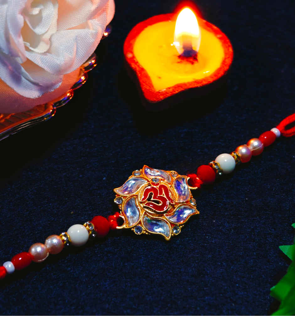 House Of Festivals Premium White Om Pendant Rakhi With Red Moti - Spiritual and Premium