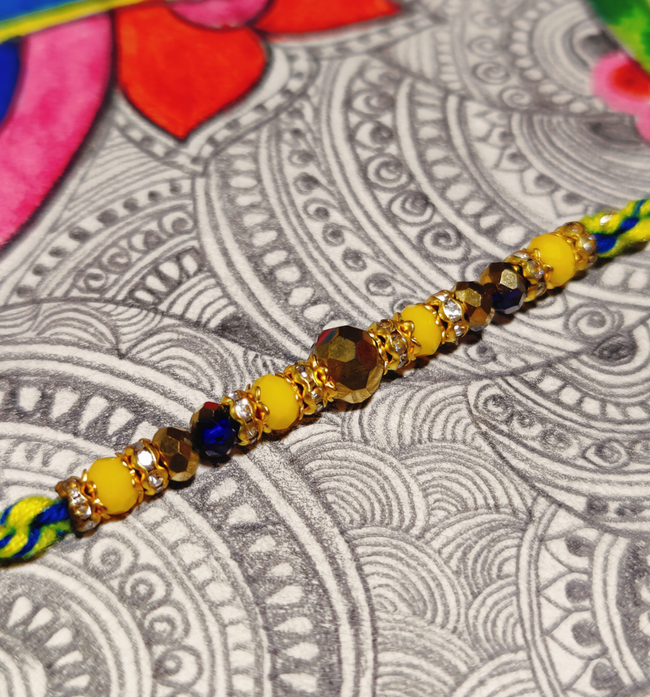 House Of Festivals Beautifully Weaved Dori Rakhi With Yellow & Blue Moti - Traditional Rakhi