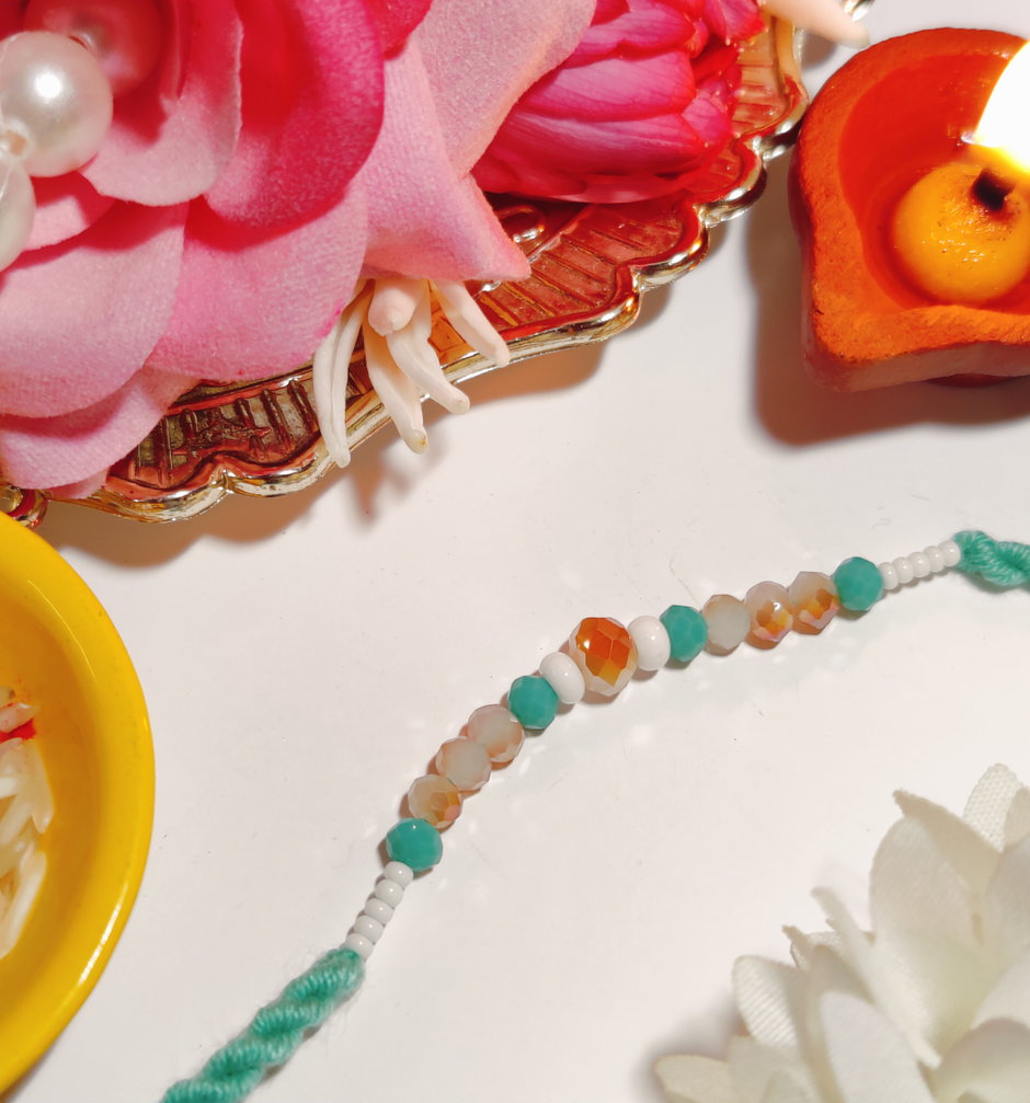 Ferrero Rocher Moments Gift Box(185gms) & Beautifully Weaved Dori Rakhi With Pastle Green & White Color Moti(1pc) Combo