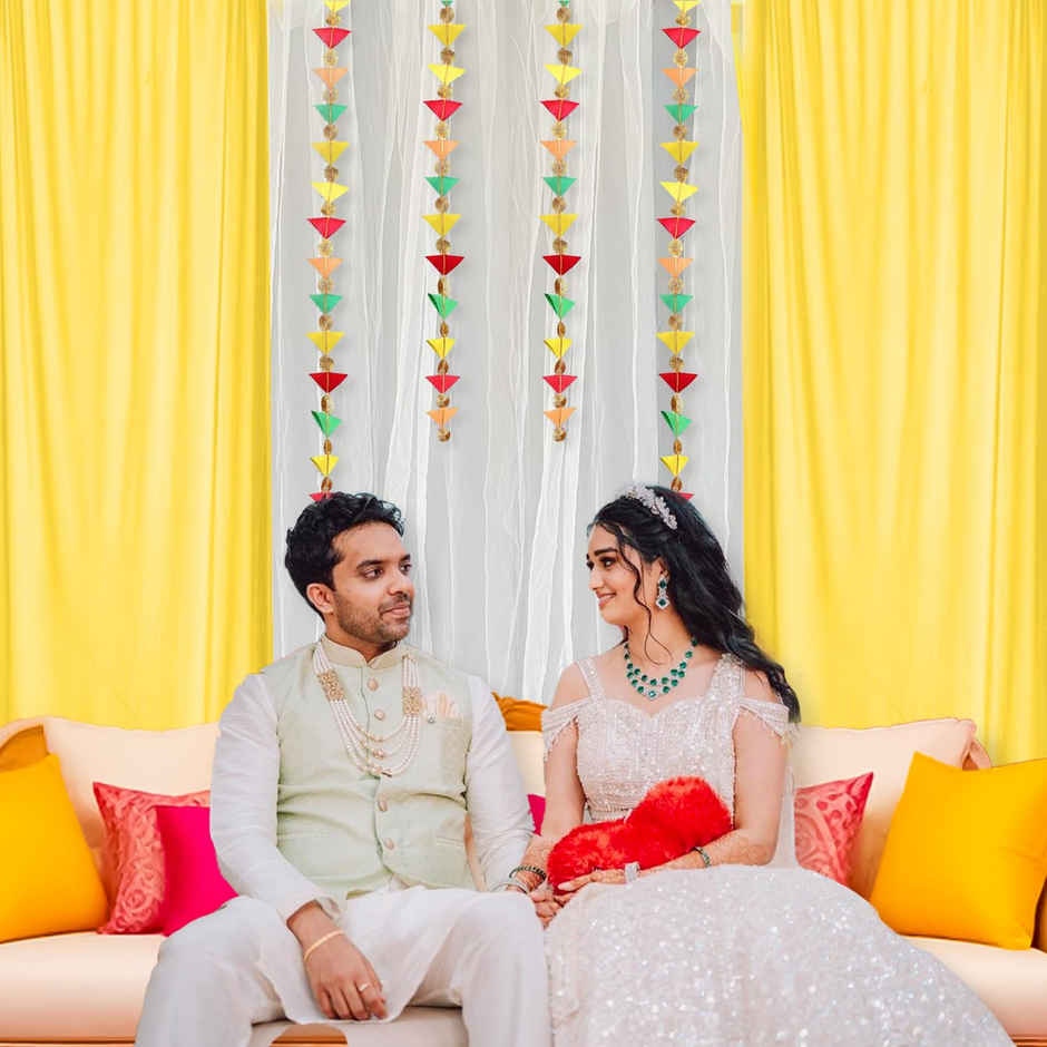 White and Yellow Net Backdrop with Triangle Hanging for Haldi Mehndi | Party Propz