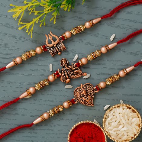 Religious Red & Golden Trishul with Damru, Lord Ganesha, & Lord Krishna Playing Flute Rakhis & Roli Chawal Pack (eCraftIndia) Set of 3