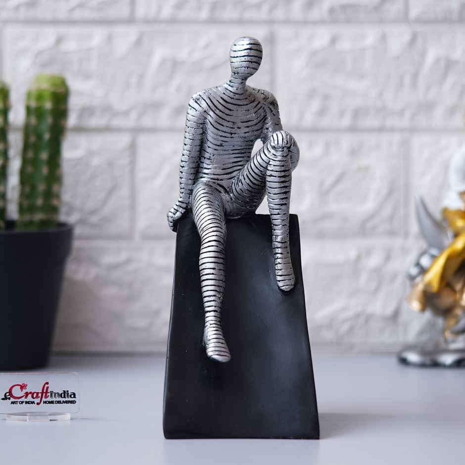 eCraftIndia Silver Man Statue Sitting on Triangle Black Base Human Showpiece