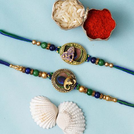 Religious Lord Ganesha and Krishna Peacock Feather Religious Rakhis for Brothers & Roli Chawal Pack (eCraftIndia) Set of 2
