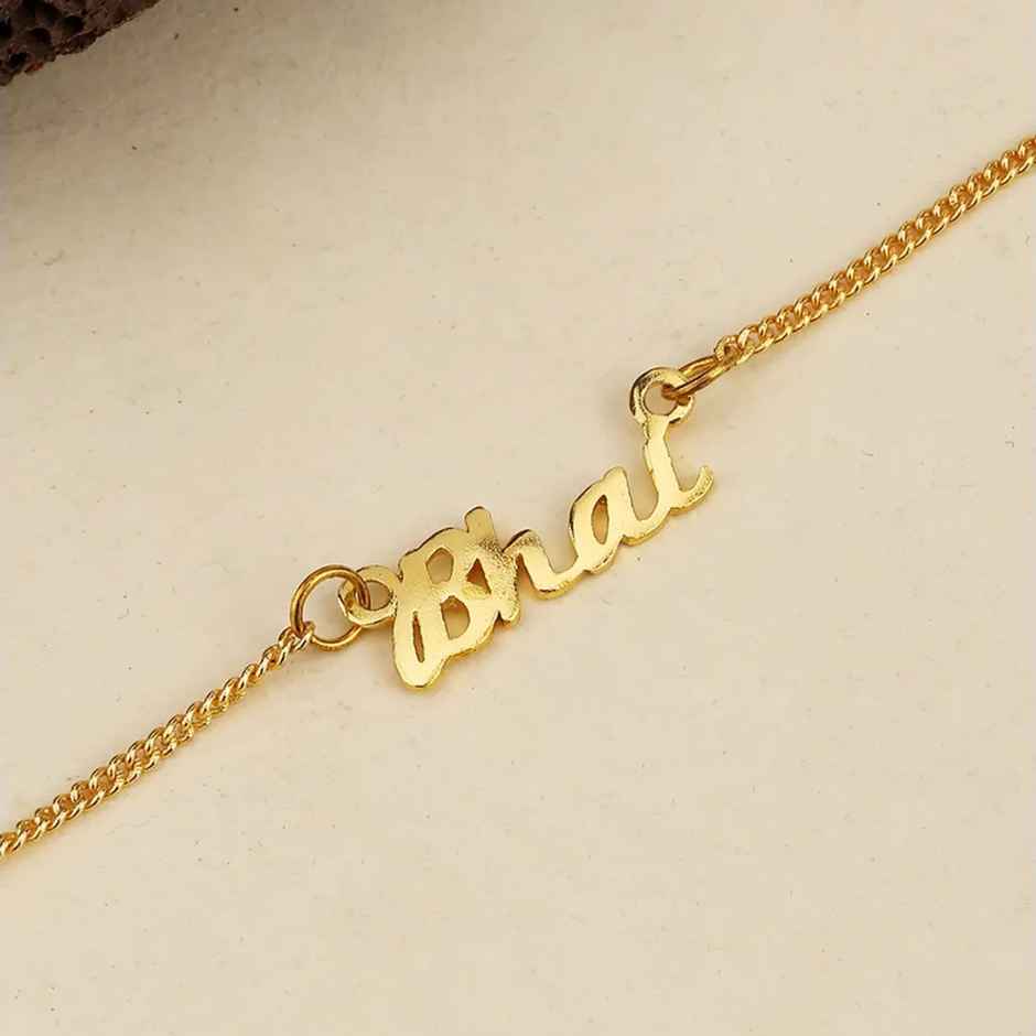 Gold-Toned Rakhi Bracelet Engraved with The Word 'Bhai' with Roli Chaawal Pack (Voylla)