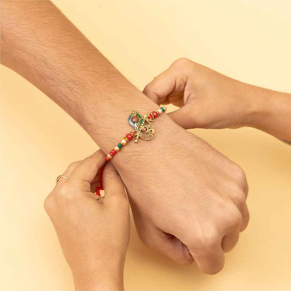 Tied Ribbons Krishna And Ganesha Rakhi For Kids With Roli Chawal (1pc) & Tied Ribbons Flute And Om Rakhi For Brother With Roli Chawal (1pc) Combo