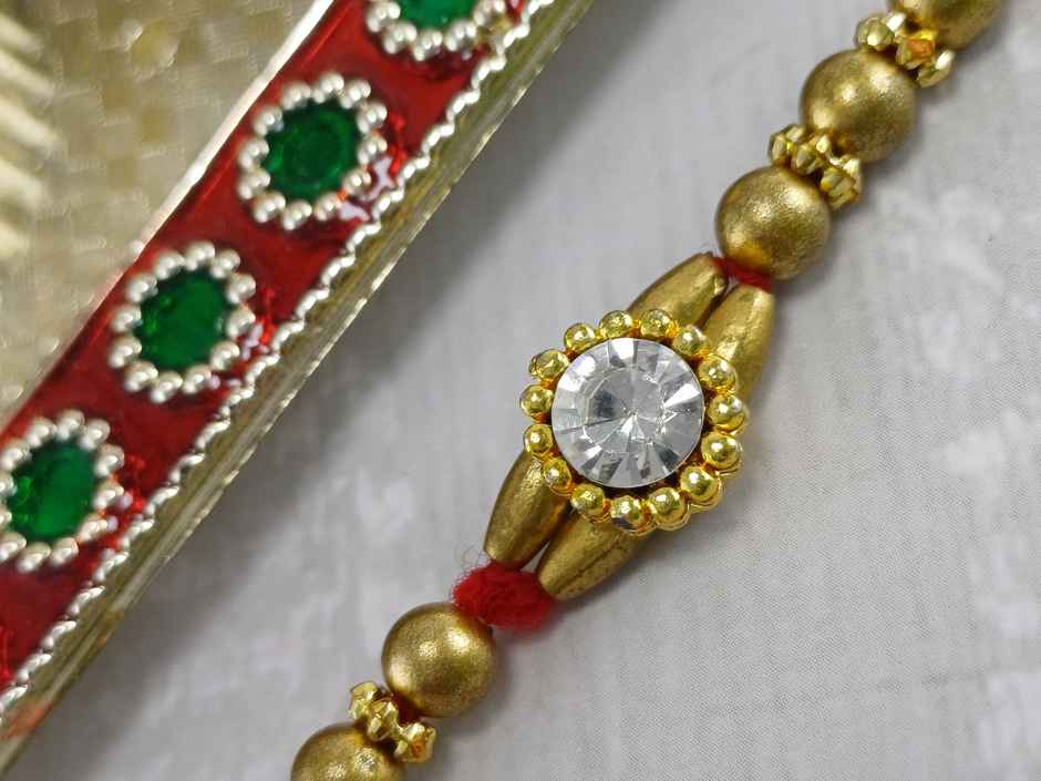 Gullak Round Small Crystal Rakhi - Simple and Elegant