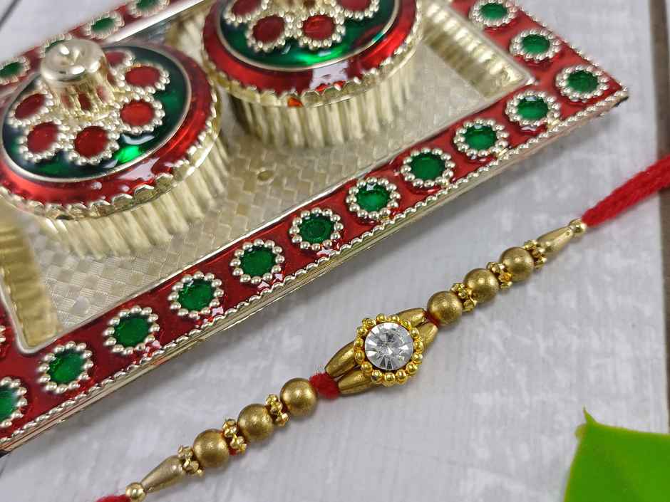 Gullak Round Small Crystal Rakhi - Simple and Elegant