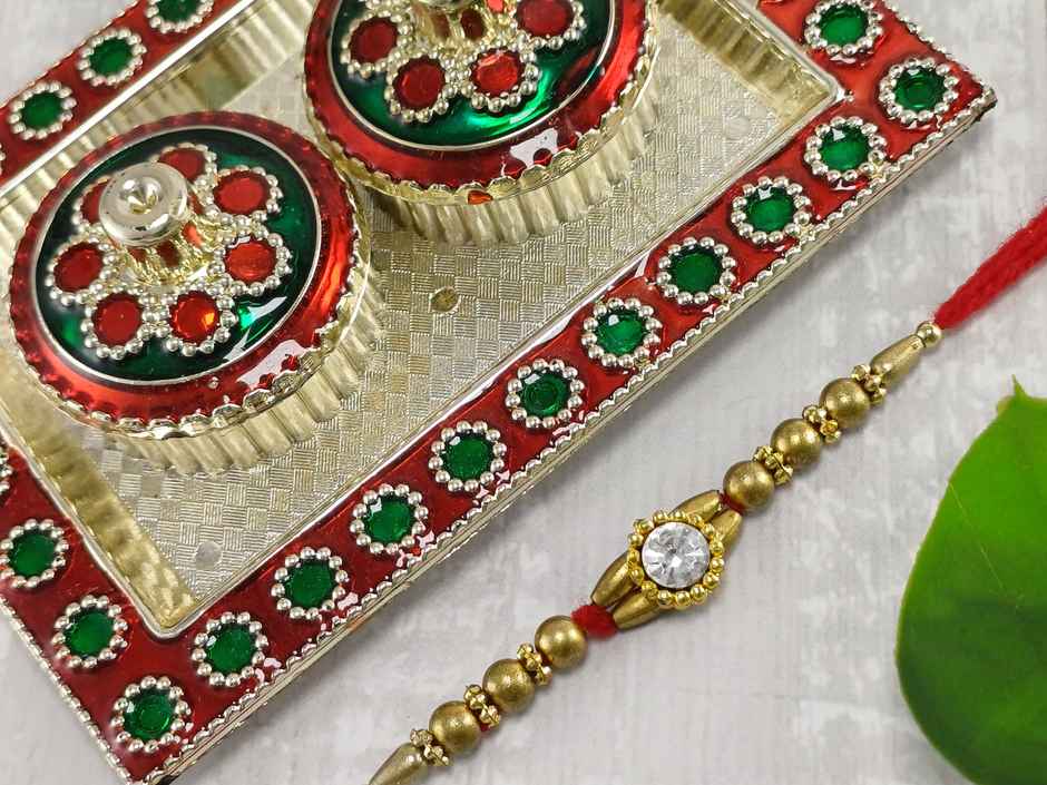 Gullak Round Small Crystal Rakhi - Simple and Elegant