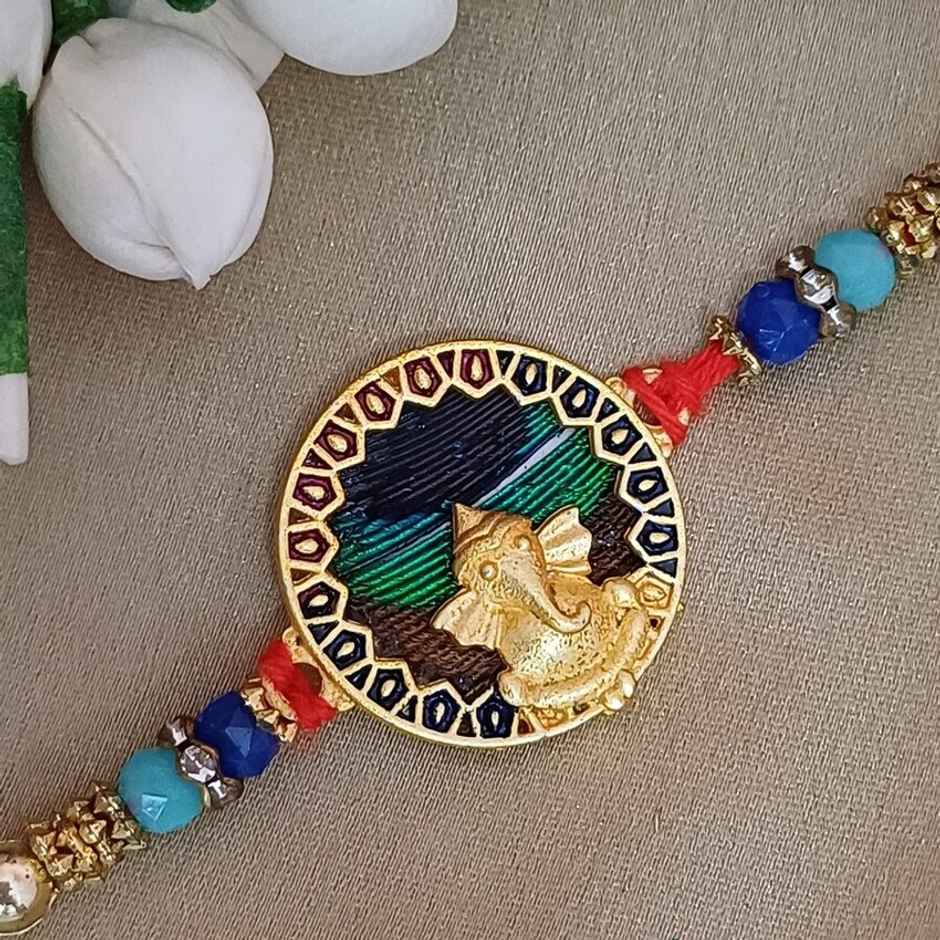 Matt Gold Metal Ganpati Round Frame Peacock Feather Rakhi | Divine and Beautiful | Gullak