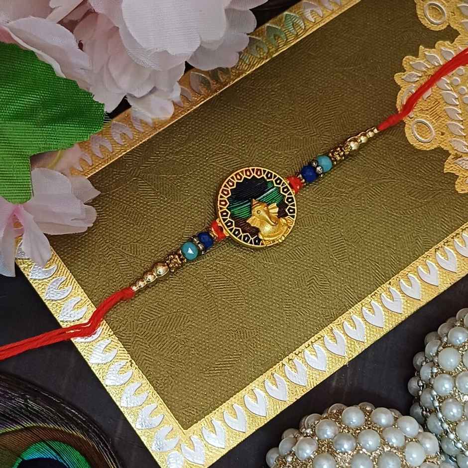Matt Gold Metal Ganpati Round Frame Peacock Feather Rakhi | Divine and Beautiful | Gullak