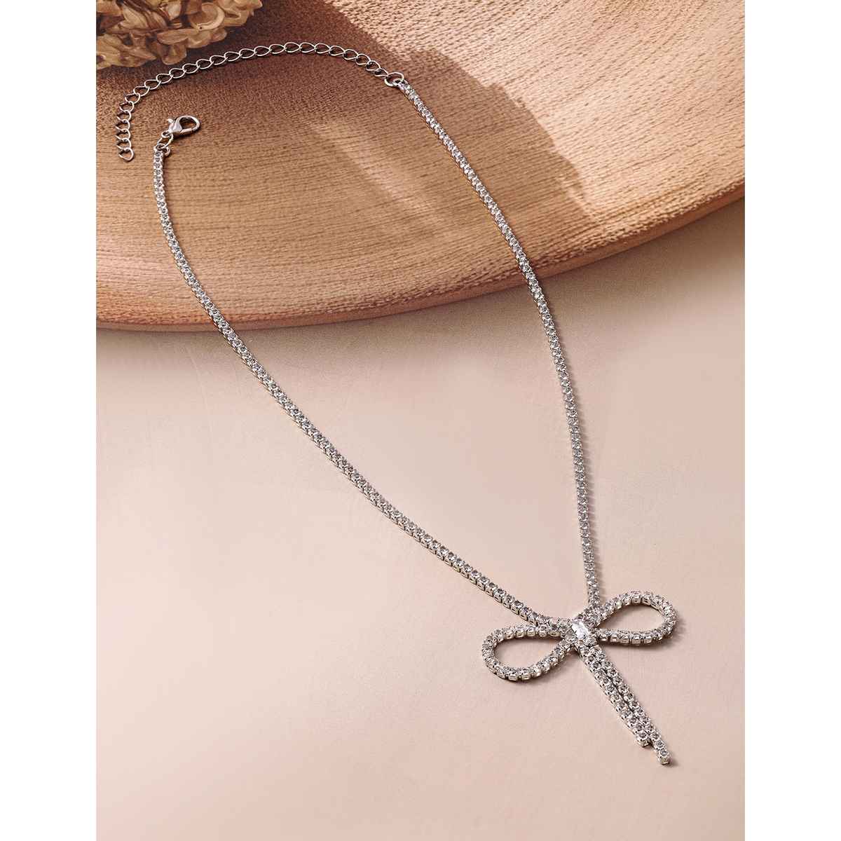 Rubans Rhodium Plated AD and Cubic Zirconia Studded Bow Design Statement Necklace
