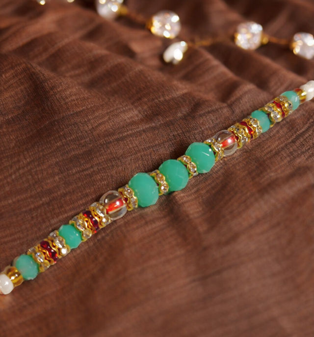 Snickers Miniatures Peanut Chocolate Bar(180gms) & Beautifully Weaved Moti Rakhi In Pastle Green & White Color(1pc) Combo