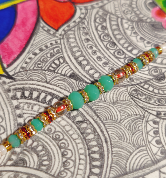 Snickers Miniatures Peanut Chocolate Bar(180gms) & Beautifully Weaved Moti Rakhi In Pastle Green & White Color(1pc) Combo