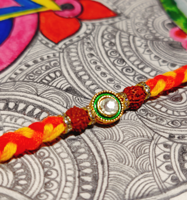 House Of Festivals Beautifully Weaved Mauli Dori Rakhi With Rudraksh & Sparkling Stone