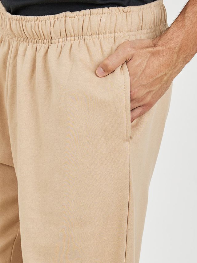 Styli Men's Relaxed Fit Jogger with Zip Pockets and Badge Detail | Beige - L