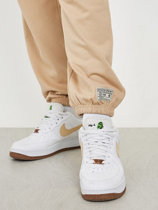 Styli Men's Relaxed Fit Jogger with Zip Pockets and Badge Detail | Beige - L