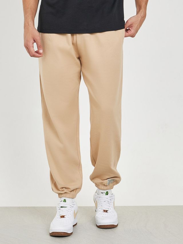 Styli Men's Relaxed Fit Jogger with Zip Pockets and Badge Detail | Beige - L