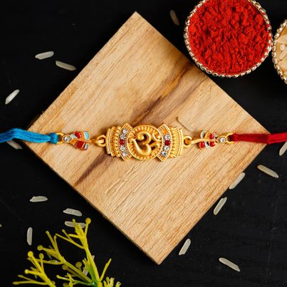 Religious Blue, Golden, Red Designer Om Symbol Rakhi & Roli Chawal Pack (eCraftIndia) Religious Blue, Golden, Red Designer Om Symbol Rakhi & Roli Chawal Pack (eCraftIndia)